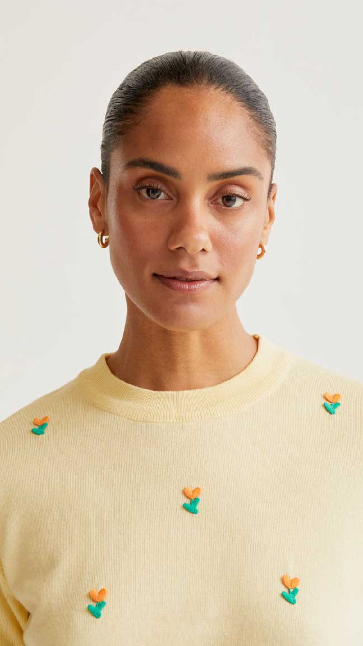 Top de punto suave amarillo con flores